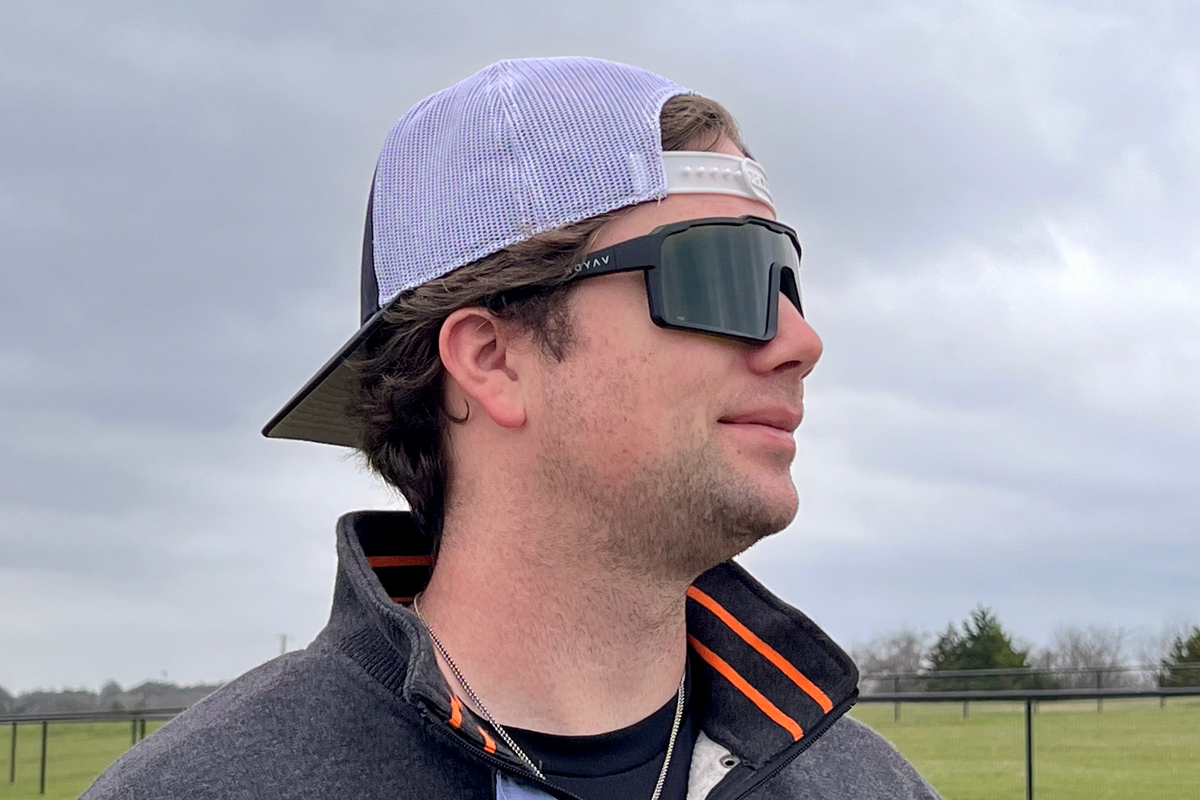 Man in a quarter-zip wearing Vaydr Veil sunglasses in an open field